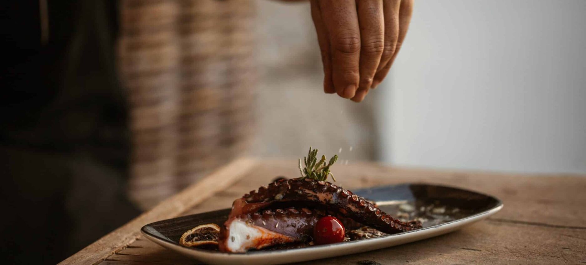 Delicious seafood being salted and final touches added before being served
