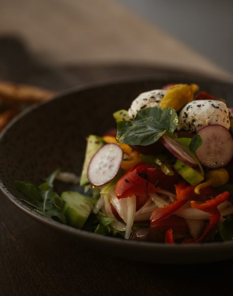 Freshly prepared salad with radish, peppers and herbed cheese served with toasted bread at Casa Cook Rhodes, showcasing local ingredients and organic flavours in a relaxed boutique hotel setting