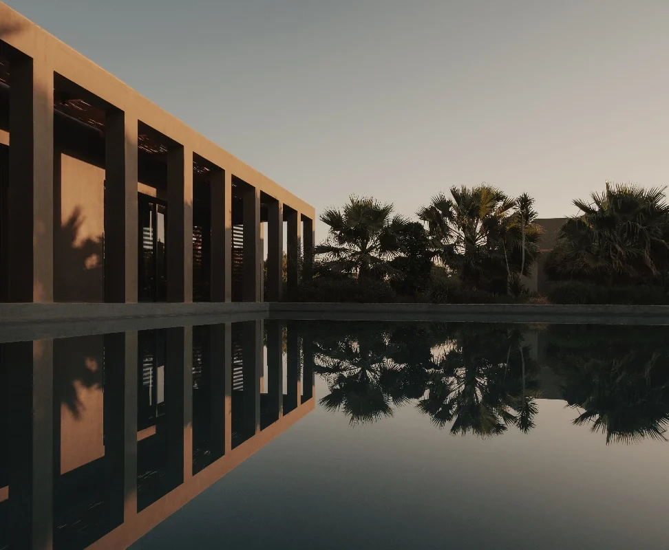 Sunset lighting over our lagoon pool with building pillars on the left hand side.