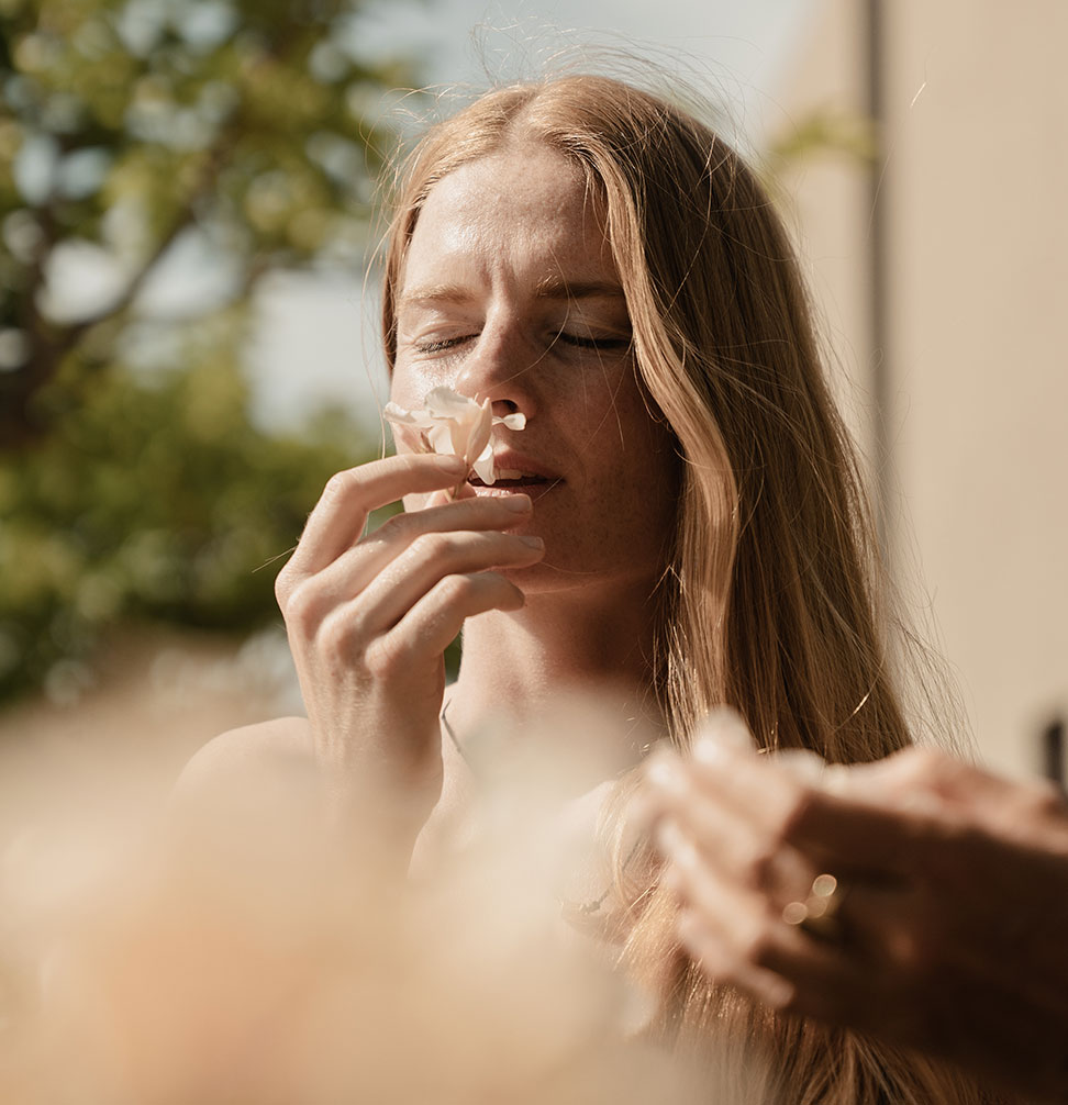 Svenja smelling a flower