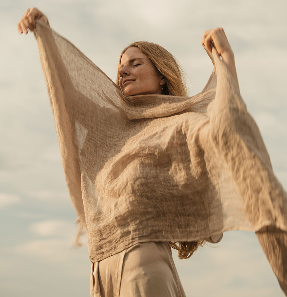Svenja standing with eyes closed facing up to the sky