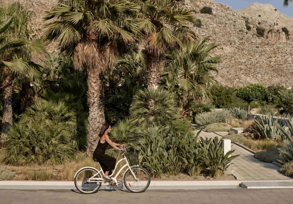 Woman riding a bike along the road at Casa Cook Rhodes