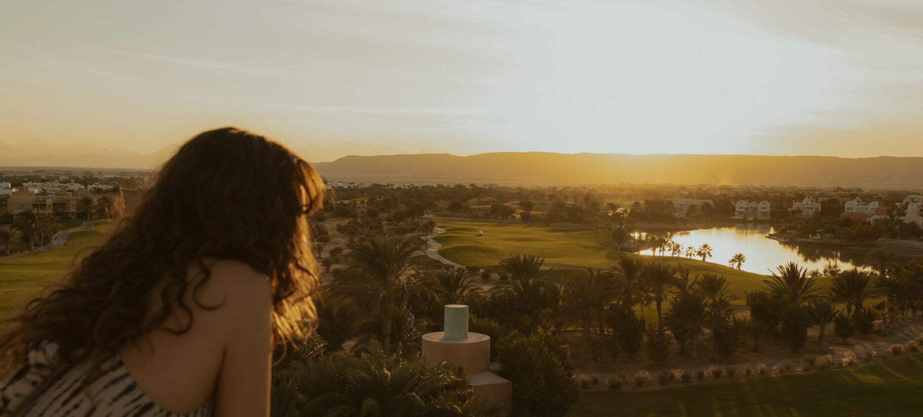 Woman leaning admiring the view of El Gouna on the Steigenberger tower experience