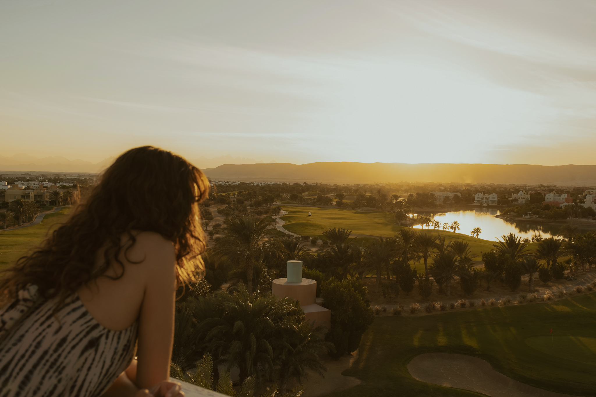 Woman leaning admiring the view of El Gouna on the Steigenberger tower experience